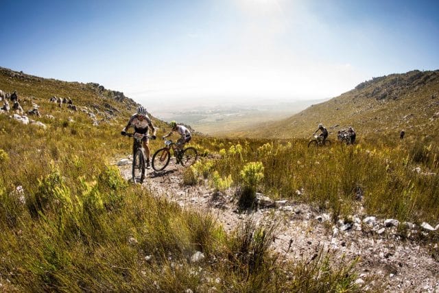 Seen here: Christoph Sauser leading Olympic and World XCO Champion Nino Schurter up the Haarkappers Roete climb during Stage 1 of the Absa Cape Epic. Photo by Nick Muzik/Cape Epic/SPORTZPICS.