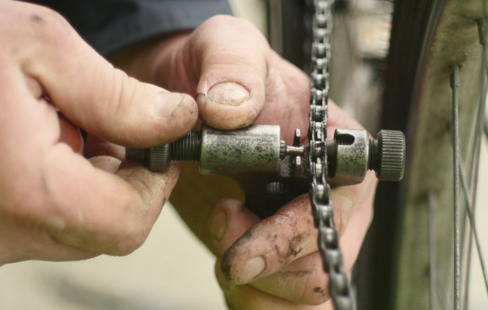 Cropped Image Of Man Fixing Bicycle Chain