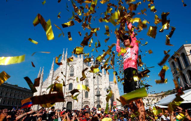 The winner of the 100th Giro d'Italia, Tour of Italy cycling race, Netherlands' Tom Dumoulin of team Sunweb holds the trophy on the podium near Milan's cathedral after the last stage, an individual time-trial between Monza and Milan, on May 28, 2017. Tom Dumoulin won the Giro 100 ahead of Colombia's Nairo Quintana of team Movistar, second, and Italy's rider of team Bahrain - Merida, Vincenzo Nibali, third. / AFP PHOTO / Luk BENIES (Photo credit should read LUK BENIES/AFP/Getty Images)