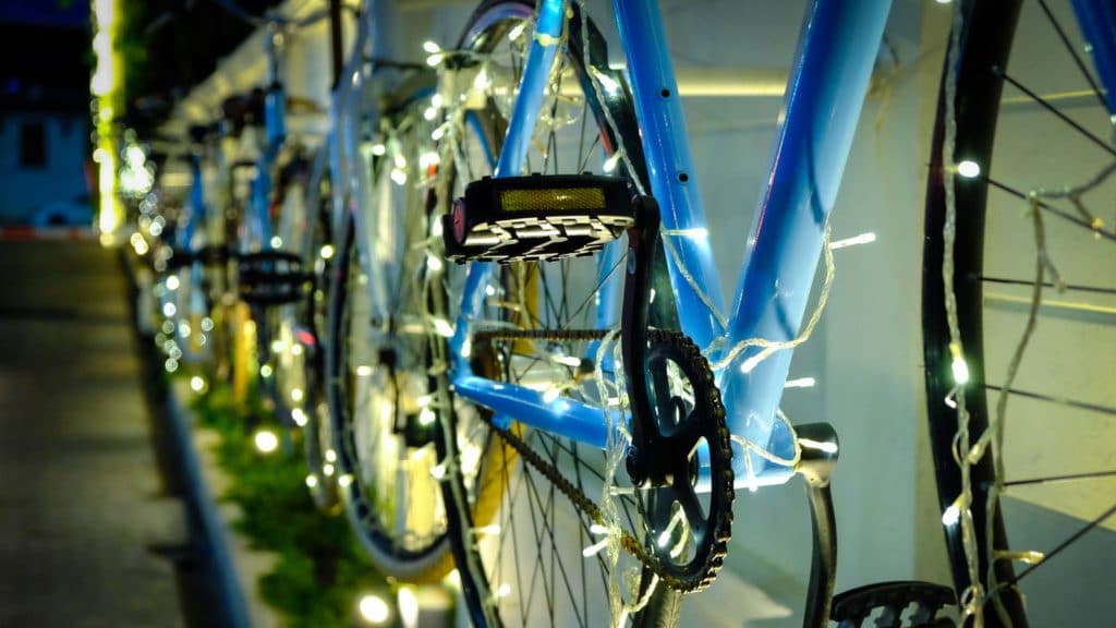 close-up-of-christmas-lights-on-bicycles-parked-by-royalty-free-image-629364851-1542723208