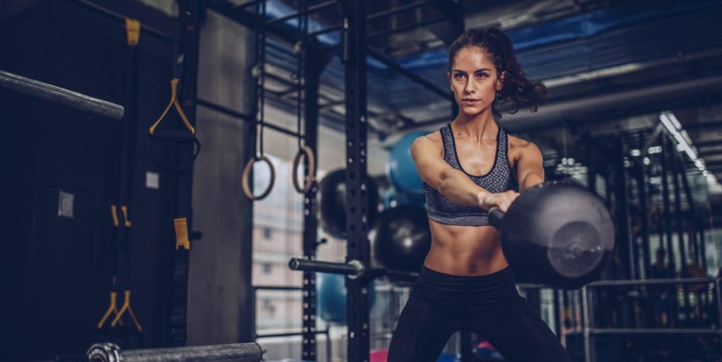 pretty-young-woman-exercising-in-gym-royalty-free-image-930919004-1541094541