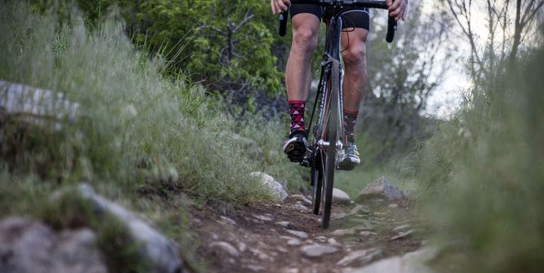 low-section-of-man-cycling-on-field-royalty-free-image-961096924-1554152355