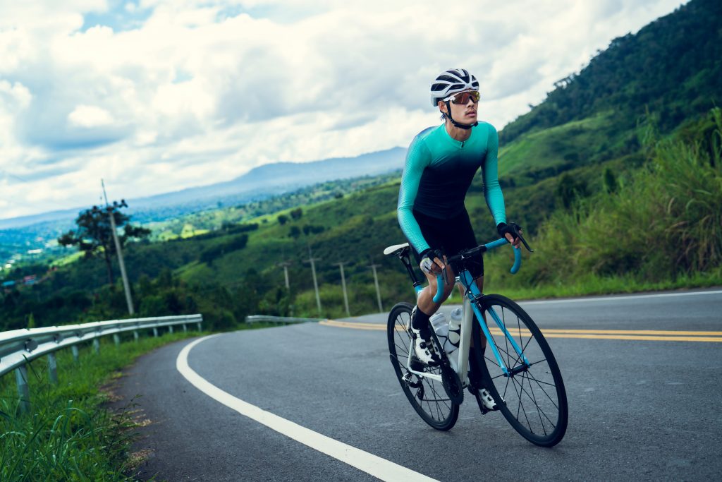 Cyclists are cycling, climbing up to the top.