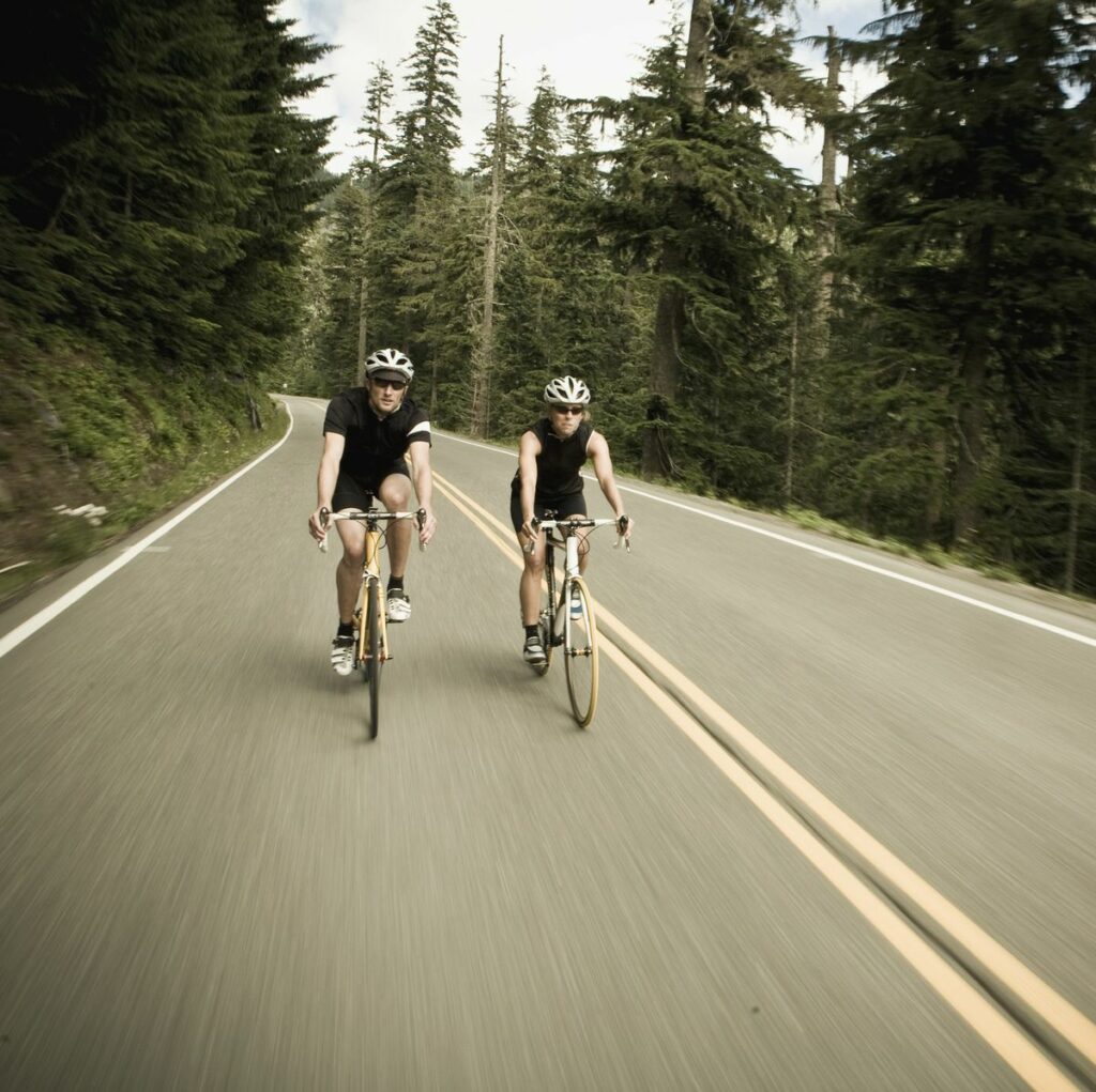 man-and-woman-bicycling-though-the-forest-royalty-free-image-1675712148