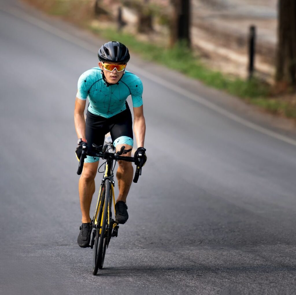cyclist-riding-a-bicycle-in-bike-lane-royalty-free-image-1683564872