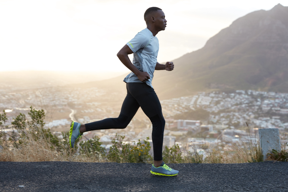 outdoor-shot-active-dark-skinned-man-running-morning-has-regular-trainings-dressed-tracksuit-comfortable-sneakers-concentrated-into-distance-sees-finish-far-away