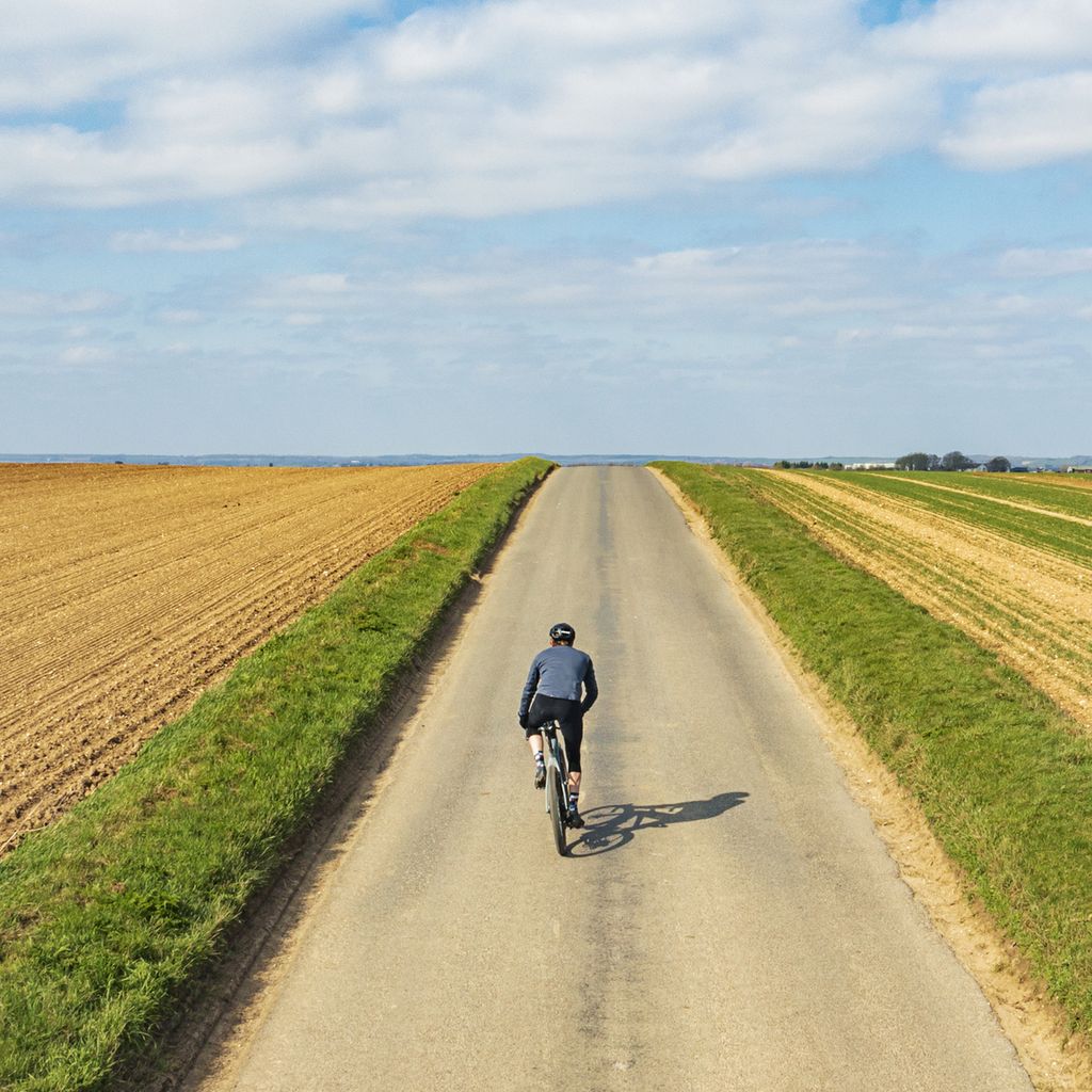 cyclist-on-road-in-countryside-royalty-free-image-1697044400