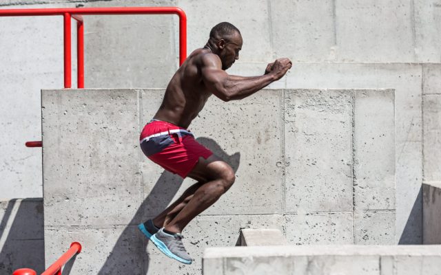 man doing a box jump as a form of cross training