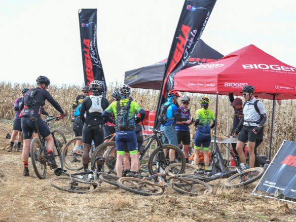 Cyclists at a waterpoint on the Honeycomb GT100Miler