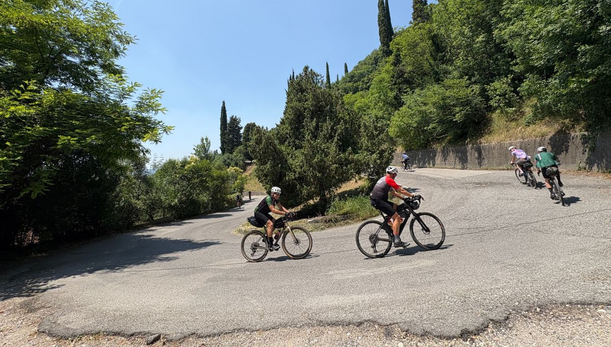 Riders climbing a hill on a tour around Lake Garda