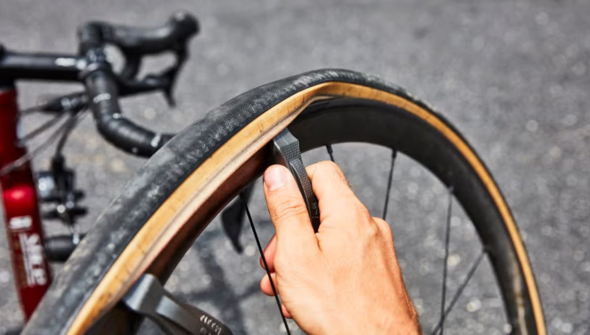 A tyre being removed using tyre levers