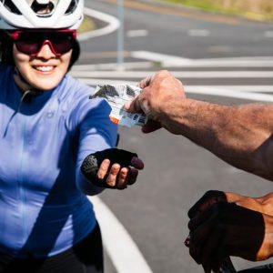 A cyclist being given some nutrition
