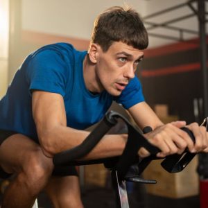 A man doing an indoor cycling workout