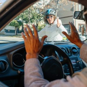 A motorist and a cyclist having an altercation.
