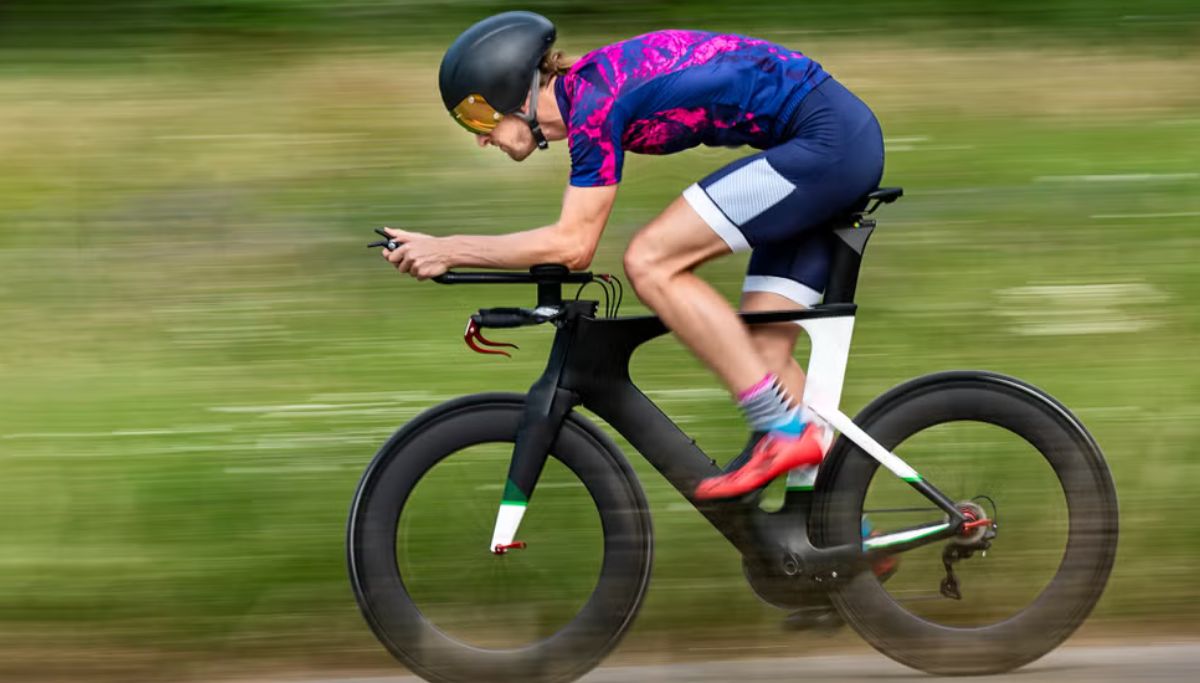 A man riding a time trial bike.