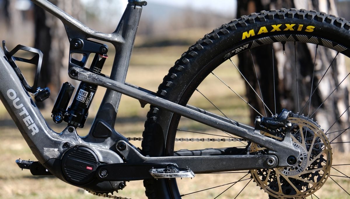 The four-bar rear suspension design has a unique counter-rotating inverted linkage.