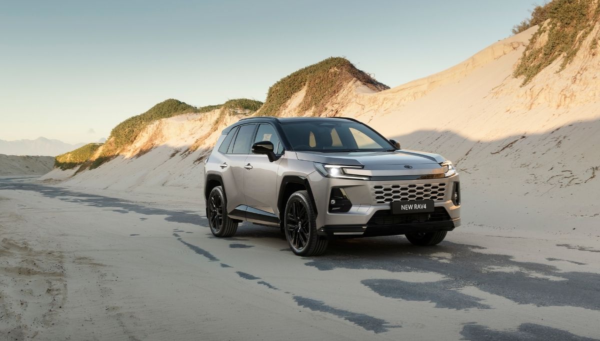 The new Toyota RAV4 driving on a beach road.